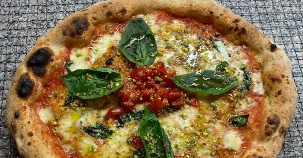pizza with spinach and dried tomato