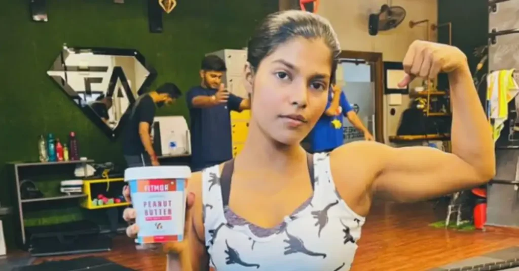 woman holding peanut butter while workout
