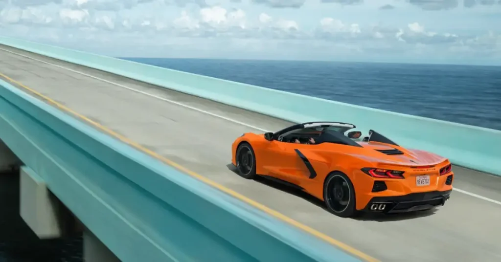 orange corvette cabrio on a bridge