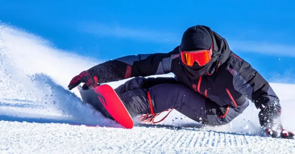 black dressed man snowboarding