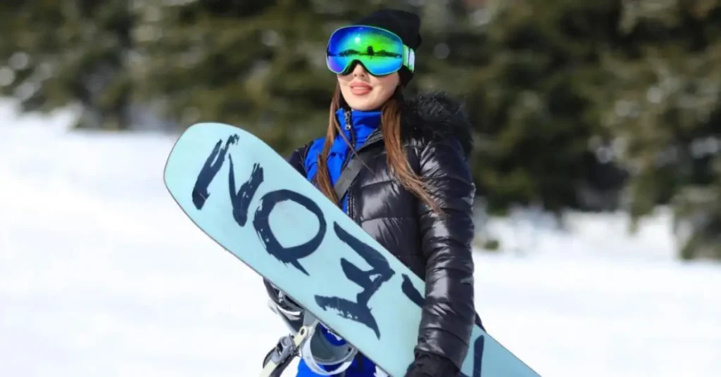 woman with brown hair and green ski glasses