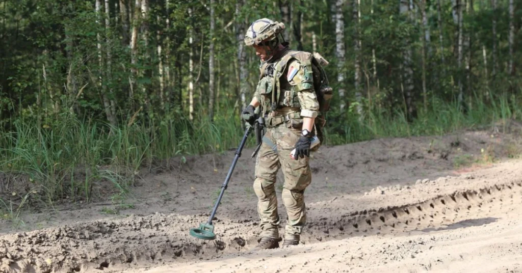 soldier with metal detector
