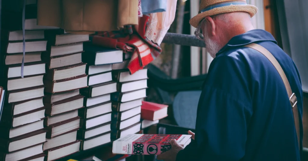 Old man infront of books