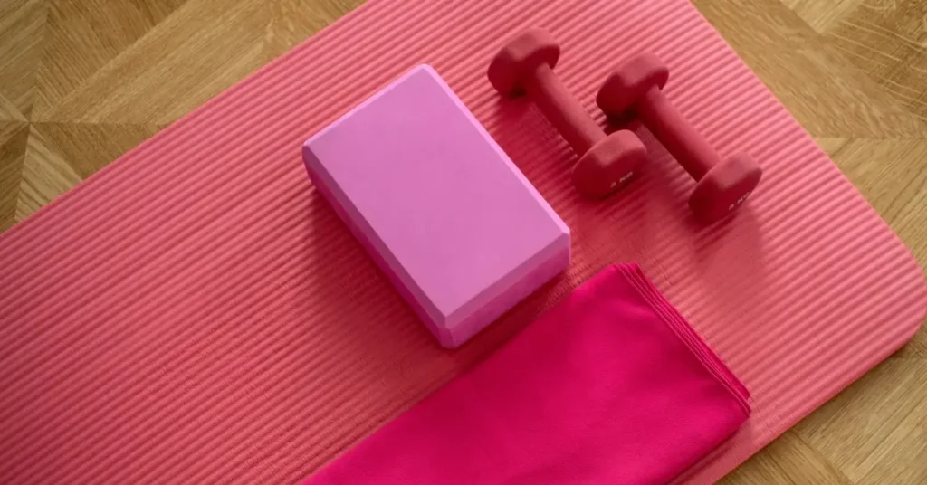pink dumbbells and yoga mat