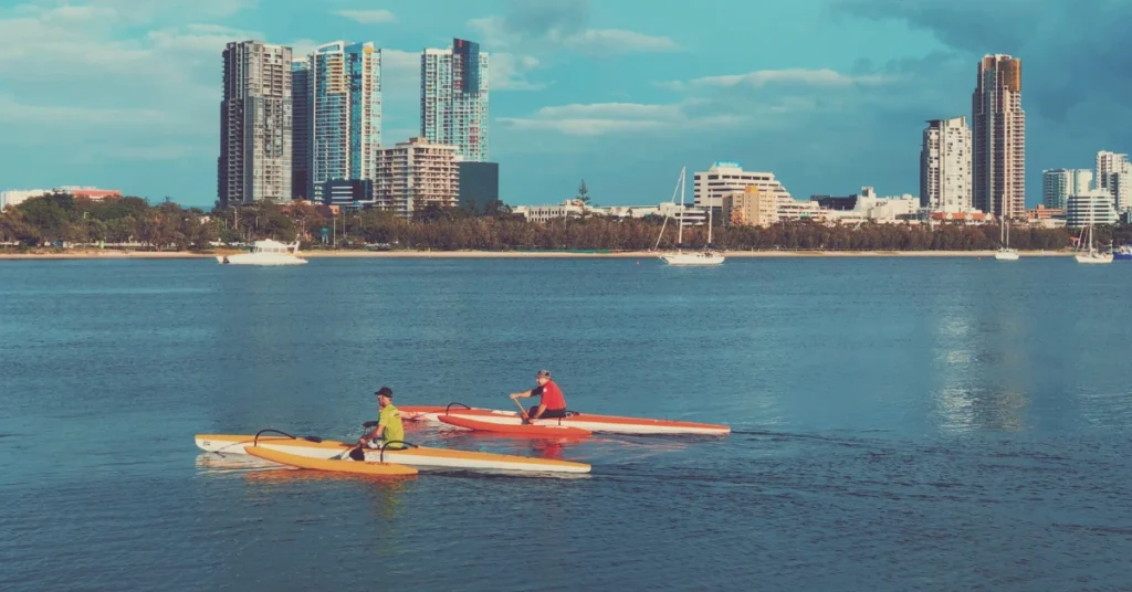 rowers in front of cities