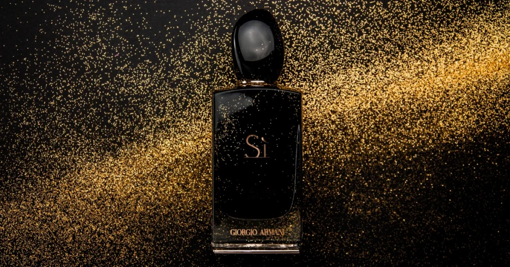 black Fragrance with gold powder in the background
