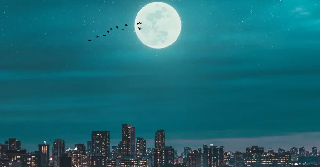 full moon over a city