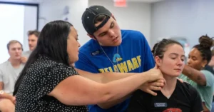 physical therapy student getting an advice from a professional