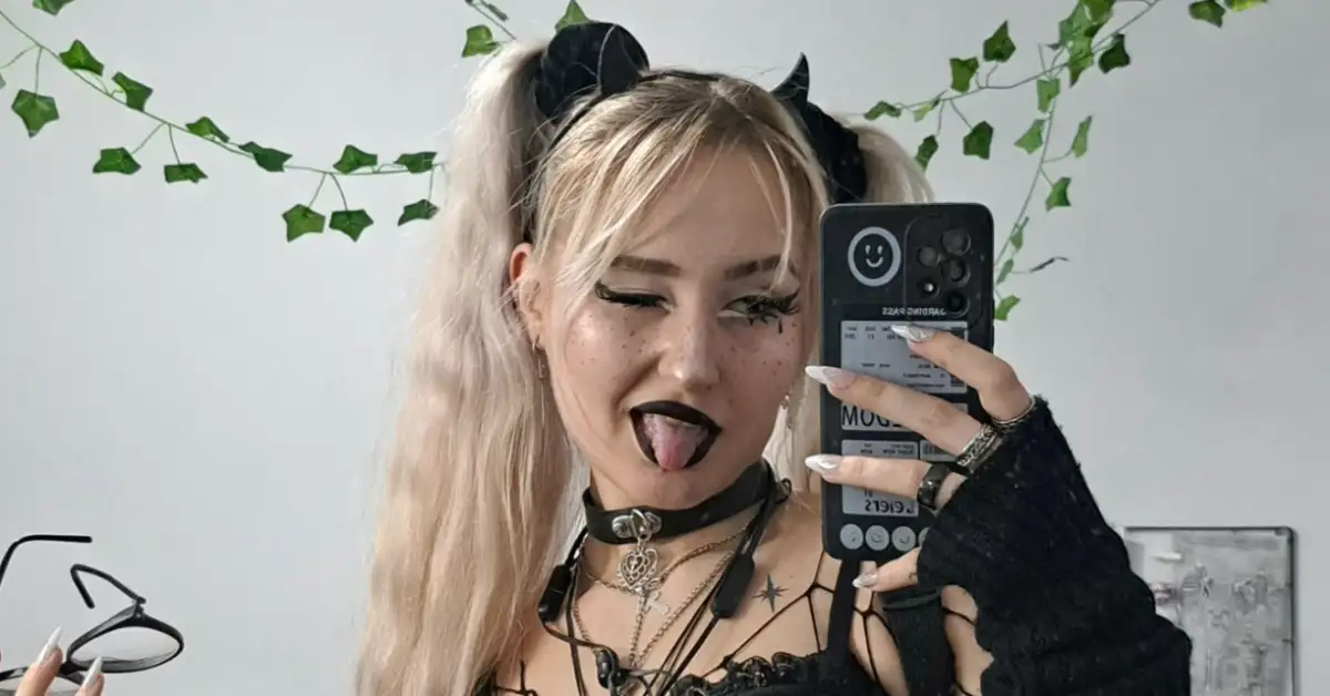young goth girl with blonde hair looking in the mirror
