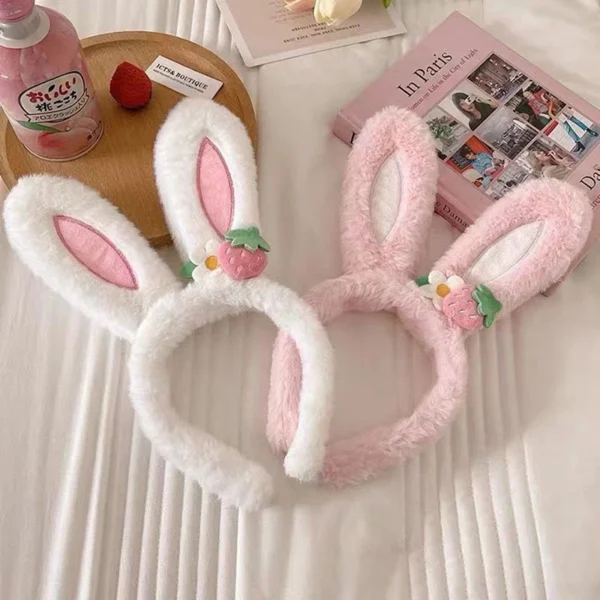 Easter Hats in pink and white next to a book and bottle