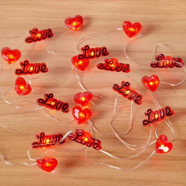 Valentines Office Decorations as fairy lights on wooden background