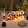 Valentines Room Decor love word written shining in red on a desk