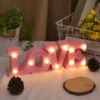 Valentines Room Decor love word written shining in pink on a desk
