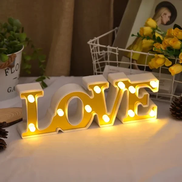 Valentines Room Decor love word written shining in white on a desk