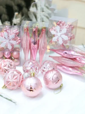 Pink Christmas Tree Decorations on white bedsheet